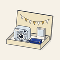 Drawing of an open gift box with an instant camera, film and a carry case
